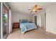 Comfortable bedroom featuring hardwood floors, ceiling fan, and a balcony with serene outdoor views at 1654 Marina Lake Dr, Kissimmee, FL 34744