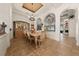 A formal dining room with tile flooring, wrought iron windows, and a chandelier hanging over the table at 1654 Marina Lake Dr, Kissimmee, FL 34744