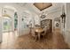 Stunning dining room with elegant chandelier, arched doorways, and views of the game room and front door at 1654 Marina Lake Dr, Kissimmee, FL 34744