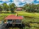 Waterfront property with a private dock and boathouse, offering direct access to the lake amidst lush greenery at 1654 Marina Lake Dr, Kissimmee, FL 34744