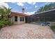 Exterior view showcasing a screened-in pool area and terracotta roof at 1654 Marina Lake Dr, Kissimmee, FL 34744