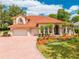 Beautiful two-story home with tile roof, manicured lawn, and well-maintained landscaping at 1654 Marina Lake Dr, Kissimmee, FL 34744