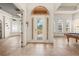View of the foyer with stone tile floors, a decorative leaded glass front door, and arched windows at 1654 Marina Lake Dr, Kissimmee, FL 34744
