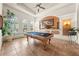 A game room with tile floors, plantation shutters, coffered ceiling, and a billiards table at 1654 Marina Lake Dr, Kissimmee, FL 34744