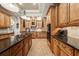 Spacious kitchen with custom wood cabinetry, granite countertops, and decorative lighting at 1654 Marina Lake Dr, Kissimmee, FL 34744