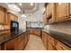 Large kitchen with custom wood cabinets, granite countertops, island, and stainless steel appliances at 1654 Marina Lake Dr, Kissimmee, FL 34744