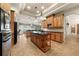 Spacious kitchen featuring granite countertops, custom cabinetry, a kitchen island, and modern black appliances at 1654 Marina Lake Dr, Kissimmee, FL 34744