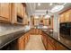 Gourmet kitchen featuring granite countertops, custom wood cabinets, and black appliances for a modern feel at 1654 Marina Lake Dr, Kissimmee, FL 34744