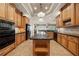 Spacious kitchen with black appliances, granite countertops, custom cabinetry, and a central island at 1654 Marina Lake Dr, Kissimmee, FL 34744