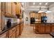Well-appointed kitchen with custom cabinetry, granite counters, an island, and sleek black appliances at 1654 Marina Lake Dr, Kissimmee, FL 34744