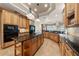 Well-equipped kitchen with granite counters, wood cabinets, and modern appliances at 1654 Marina Lake Dr, Kissimmee, FL 34744