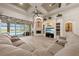 Open-concept living room with a fireplace, built-in shelving, and a view of the pool at 1654 Marina Lake Dr, Kissimmee, FL 34744