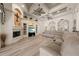 Bright living room featuring a fireplace, built-in shelving, tile floors, and coffered ceilings with fans at 1654 Marina Lake Dr, Kissimmee, FL 34744