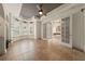 An open living room featuring tile floors, tray ceiling, and arched doorways leading into other rooms at 1654 Marina Lake Dr, Kissimmee, FL 34744