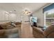 Bright living room features a TV, comfortable seating, hardwood floors, and lots of natural light at 1654 Marina Lake Dr, Kissimmee, FL 34744