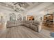 Open-concept living room with coffered ceiling, tile floors, and a large sectional sofa for comfortable seating at 1654 Marina Lake Dr, Kissimmee, FL 34744