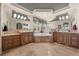 Luxurious main bathroom with dual sinks, vanity, large mirrors, and tiled jacuzzi-style tub at 1654 Marina Lake Dr, Kissimmee, FL 34744