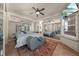 Beautiful main bedroom featuring mirrored walls, a ceiling fan, and natural light at 1654 Marina Lake Dr, Kissimmee, FL 34744