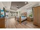 Bright main bedroom features tray ceilings, wood floors, and plentiful natural light from multiple windows at 1654 Marina Lake Dr, Kissimmee, FL 34744