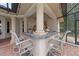 Covered outdoor bar area with seating and views of the lush surroundings at 1654 Marina Lake Dr, Kissimmee, FL 34744