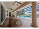 Inviting patio with seating area overlooking the pool and serene backyard at 1654 Marina Lake Dr, Kissimmee, FL 34744