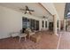 Covered patio features a ceiling fan, a wicker seating area, and tile flooring at 1654 Marina Lake Dr, Kissimmee, FL 34744