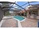 Outdoor pool and patio area with an enclosed screen, jacuzzi and bar with seating at 1654 Marina Lake Dr, Kissimmee, FL 34744