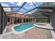 Stunning screened-in pool with a hot tub and ample brick patio space for entertaining and relaxation at 1654 Marina Lake Dr, Kissimmee, FL 34744