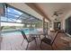 Relaxing patio with a table, chairs, and a view of the pool and pond at 1654 Marina Lake Dr, Kissimmee, FL 34744