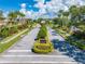Gated community entrance with lush landscaping and palm trees on a sunny day at 1654 Marina Lake Dr, Kissimmee, FL 34744