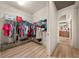 View of a walk-in closet with shelving and a glimpse into a connecting bathroom at 1654 Marina Lake Dr, Kissimmee, FL 34744