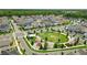 Aerial view of neighborhood featuring playground, green space, and pond at 1850 Treasure Cv, Celebration, FL 34747