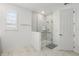 Well-lit bathroom with a glass-enclosed shower featuring safety bars, marble-look tiles and a window with shutters at 1850 Treasure Cv, Celebration, FL 34747