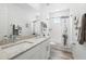Clean bathroom featuring a double vanity with granite countertop, white cabinets, and a shower-tub combo at 1850 Treasure Cv, Celebration, FL 34747