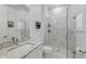 Modern bathroom featuring a glass shower, marble tile, and a white vanity with a stone countertop at 1850 Treasure Cv, Celebration, FL 34747