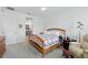 Spacious bedroom with carpet, a cozy quilt on the bed, and an adjoining bathroom visible through the doorway at 1850 Treasure Cv, Celebration, FL 34747