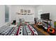 Bedroom with modern decor, television, and a cozy recliner for relaxing after a long day at 1850 Treasure Cv, Celebration, FL 34747