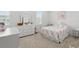 Charming bedroom with a pastel quilt, a white dresser, and soft natural light from the window at 1850 Treasure Cv, Celebration, FL 34747
