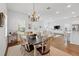 Cozy dining space with hardwood floors, a chandelier, and an open layout provides comfortable living at 1850 Treasure Cv, Celebration, FL 34747