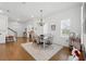 Dining area with hardwood floors, a chandelier, and an adjacent staircase adds charm to the living space at 1850 Treasure Cv, Celebration, FL 34747