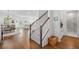 Bright entryway features hardwood floors, staircase with gray carpet, and a view of the dining and living room at 1850 Treasure Cv, Celebration, FL 34747