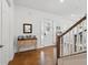 Open foyer with hardwood floors, a hall table, and front door with sidelights create a welcoming entrance at 1850 Treasure Cv, Celebration, FL 34747