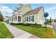 Charming home with an inviting front porch, manicured lawn, and attached garage at 1850 Treasure Cv, Celebration, FL 34747