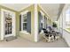 Inviting front porch with comfortable seating area, side door entrance, and decorative welcome mat at 1850 Treasure Cv, Celebration, FL 34747