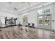 Well-lit gym featuring weights, stationary bikes, and rowing machines for a comprehensive workout experience at 1850 Treasure Cv, Celebration, FL 34747
