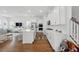 Modern, open kitchen design with hardwood floors, a center island, and a staircase creates a functional layout at 1850 Treasure Cv, Celebration, FL 34747
