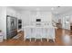 Bright kitchen features white cabinets, stainless steel appliances, an island with seating, and hardwood floors at 1850 Treasure Cv, Celebration, FL 34747