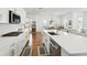 Gourmet kitchen featuring quartz countertops, a gas cooktop, stainless steel appliances, and wood flooring at 1850 Treasure Cv, Celebration, FL 34747