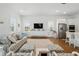 Open concept living room with a kitchen island, stainless steel appliances, and a comfortable sitting area at 1850 Treasure Cv, Celebration, FL 34747