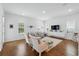 Spacious living room with lots of natural light, featuring hardwood floors, neutral decor and comfortable seating at 1850 Treasure Cv, Celebration, FL 34747